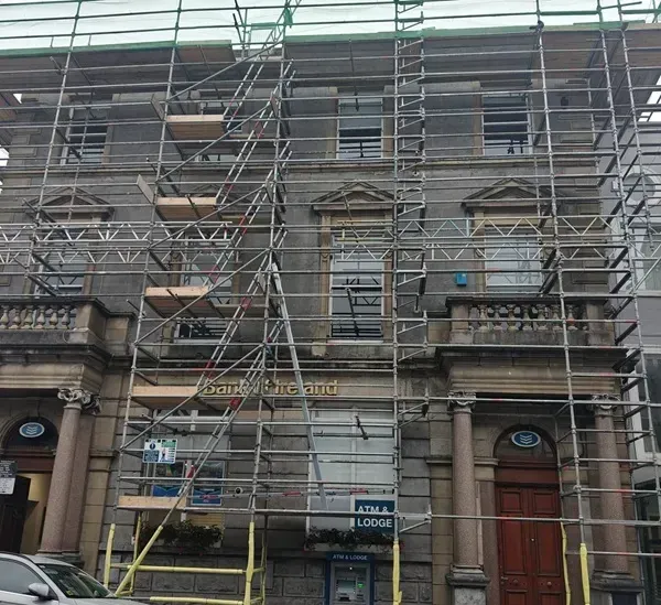 Scaffolded bank building during gutter and roofline restoration